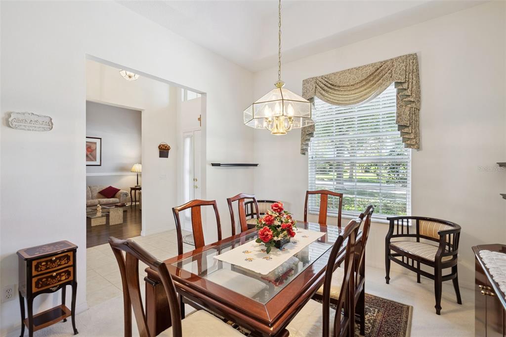 1584 Cherry Ridge Drive Lake Mary, FL 32746 - Photo 24 of 62 a view of a dining room with furniture a chandelier and wooden floor