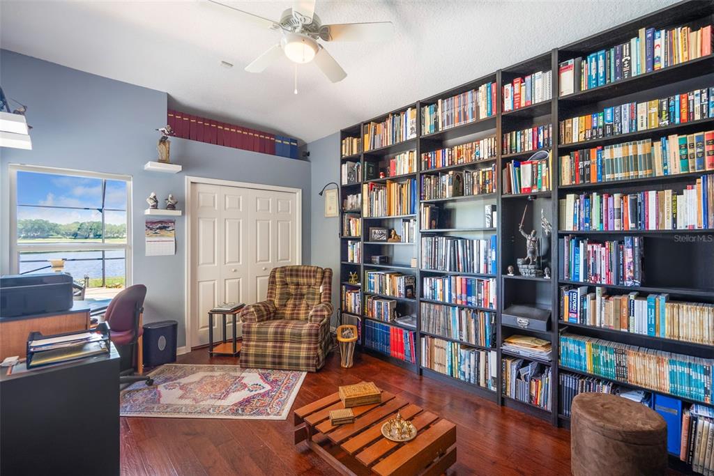1584 Cherry Ridge Drive Lake Mary, FL 32746 - Photo 35 of 62 a living room with furniture lots of books and a book shelf