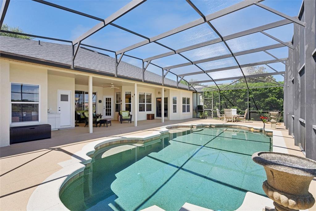 1584 Cherry Ridge Drive Lake Mary, FL 32746 - Photo 46 of 62 a view of a patio with a table and chairs under an umbrella
