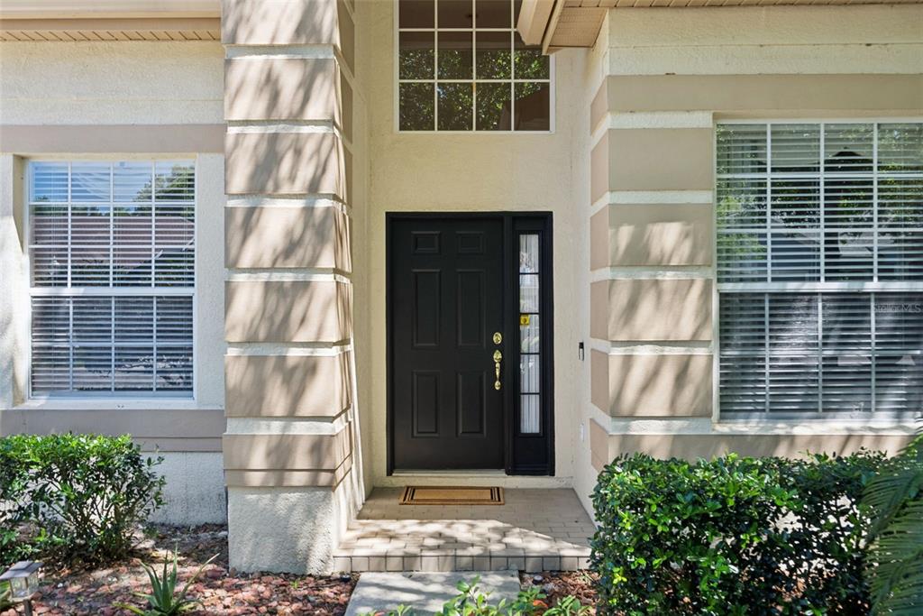 1584 Cherry Ridge Drive Lake Mary, FL 32746 - Photo 5 of 62 a front view of a house with a garden