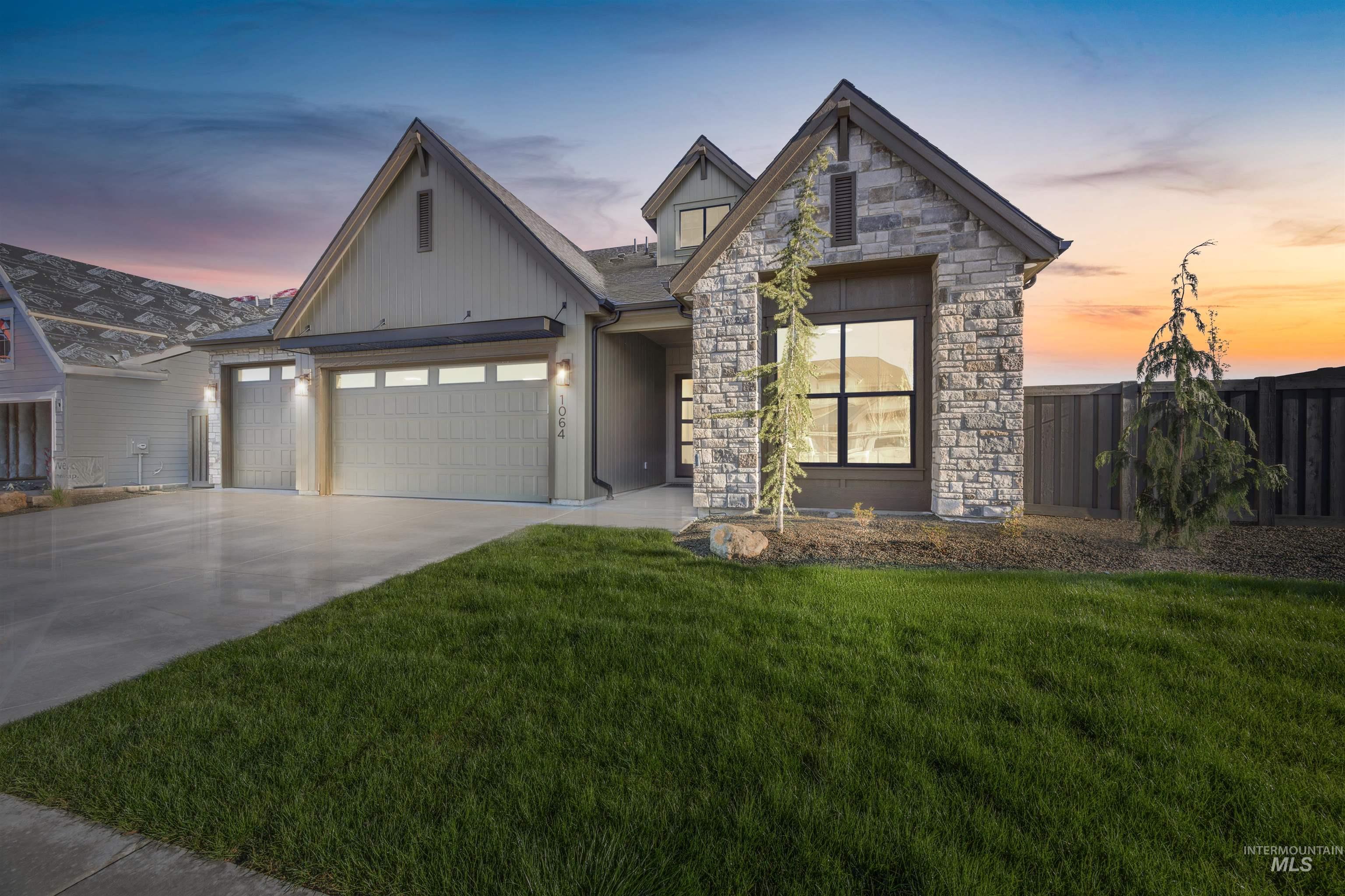 5847 South Pinpoint Way Meridian, ID 83642 - Photo 44 of 44 View of front of house featuring an attached garage, concrete driveway, and stone siding