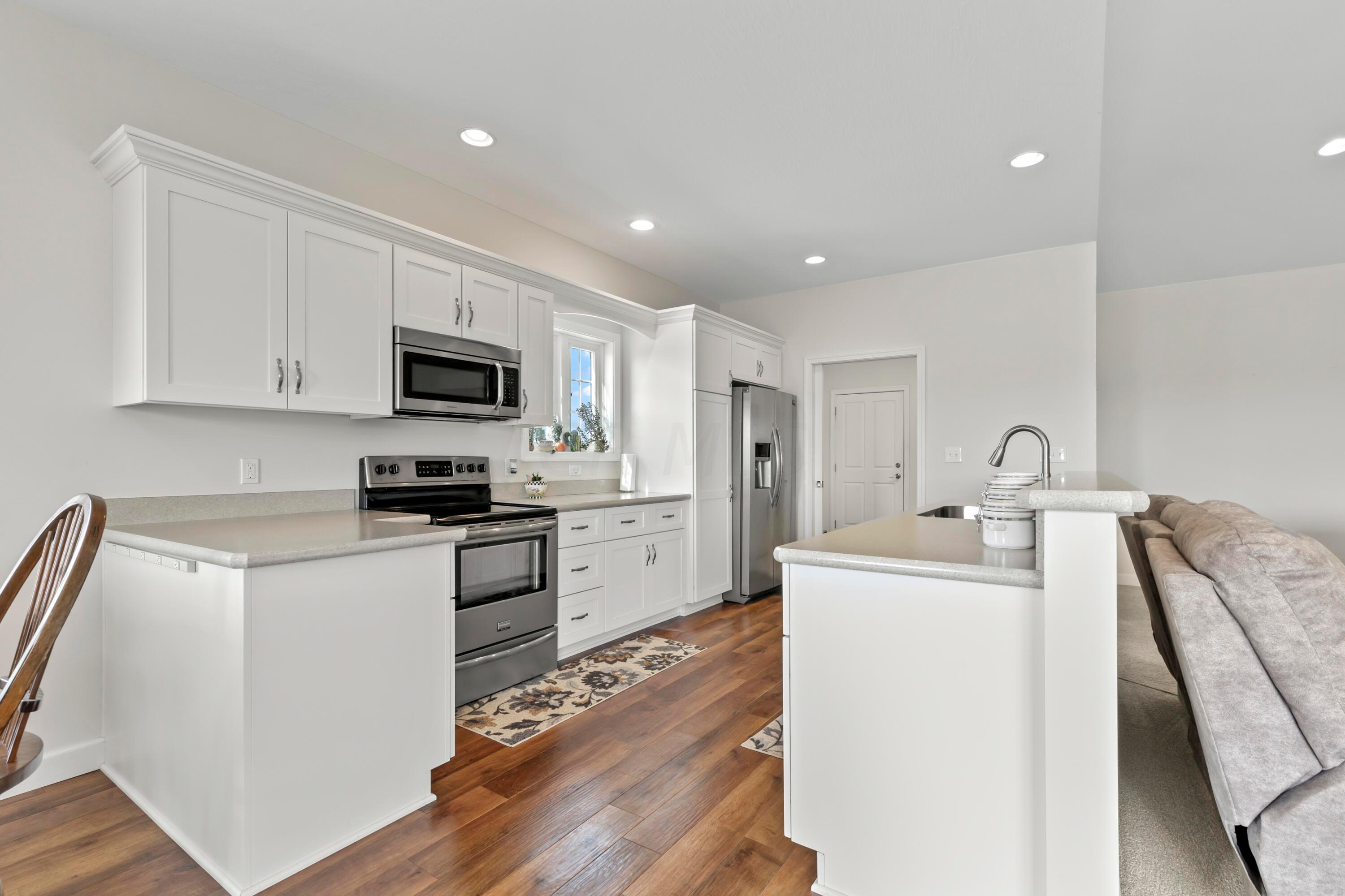 3644 Panhandle Road Delaware, OH 43015 - Photo 26 of 46 • High definition, “wood look”
laminate flooring
• Ivory painted walls
• Can lighting
• Frigidaire® microwave
• Frigidaire® electric range
• Frigidaire® dishwasher
• Frigidaire® refrigerator
• White cabinets
• Double bowl, stainless steel sink
with sprayer
• Insinkerator disposal
• Breakfast bar ledge