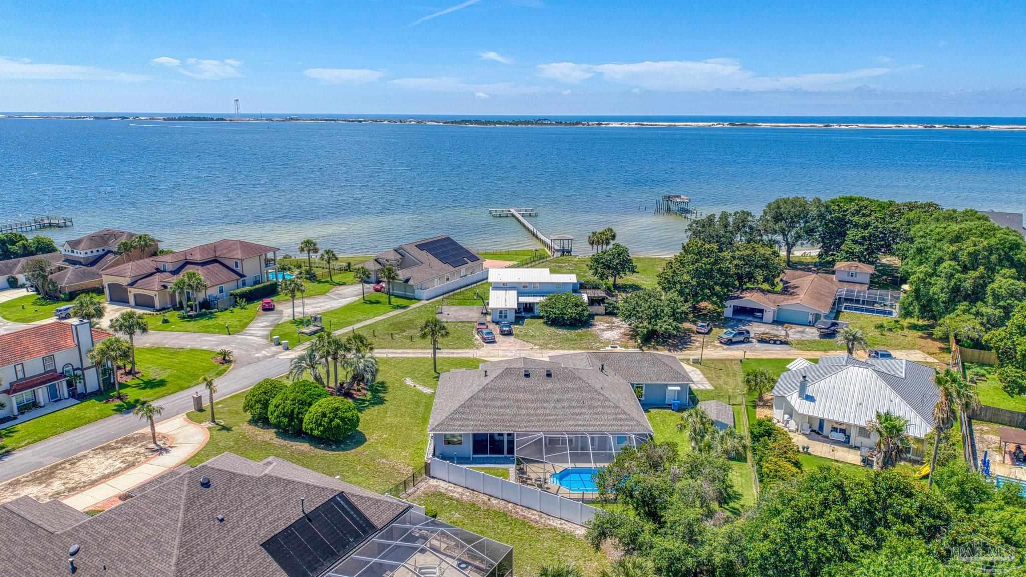 2005 Riviera Lane South Navarre, FL 32566 - Photo 58 of 70 an aerial view of a house with a swimming pool outdoor seating and yard