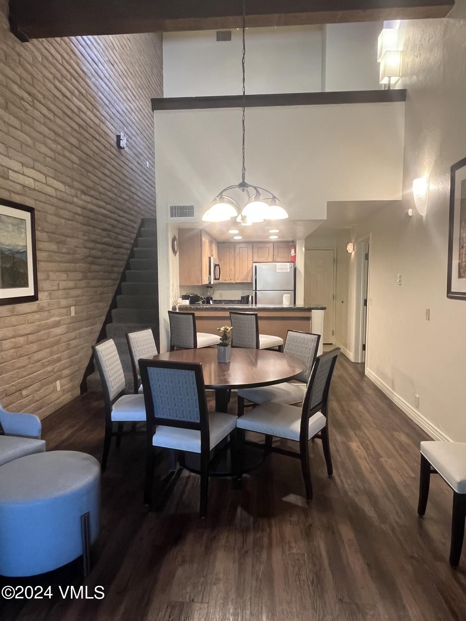 1020 Vail View Drive, Unit 340846 Vail, CO 81657 - Photo 6 of 25 a view of a dining room with furniture and wooden floor