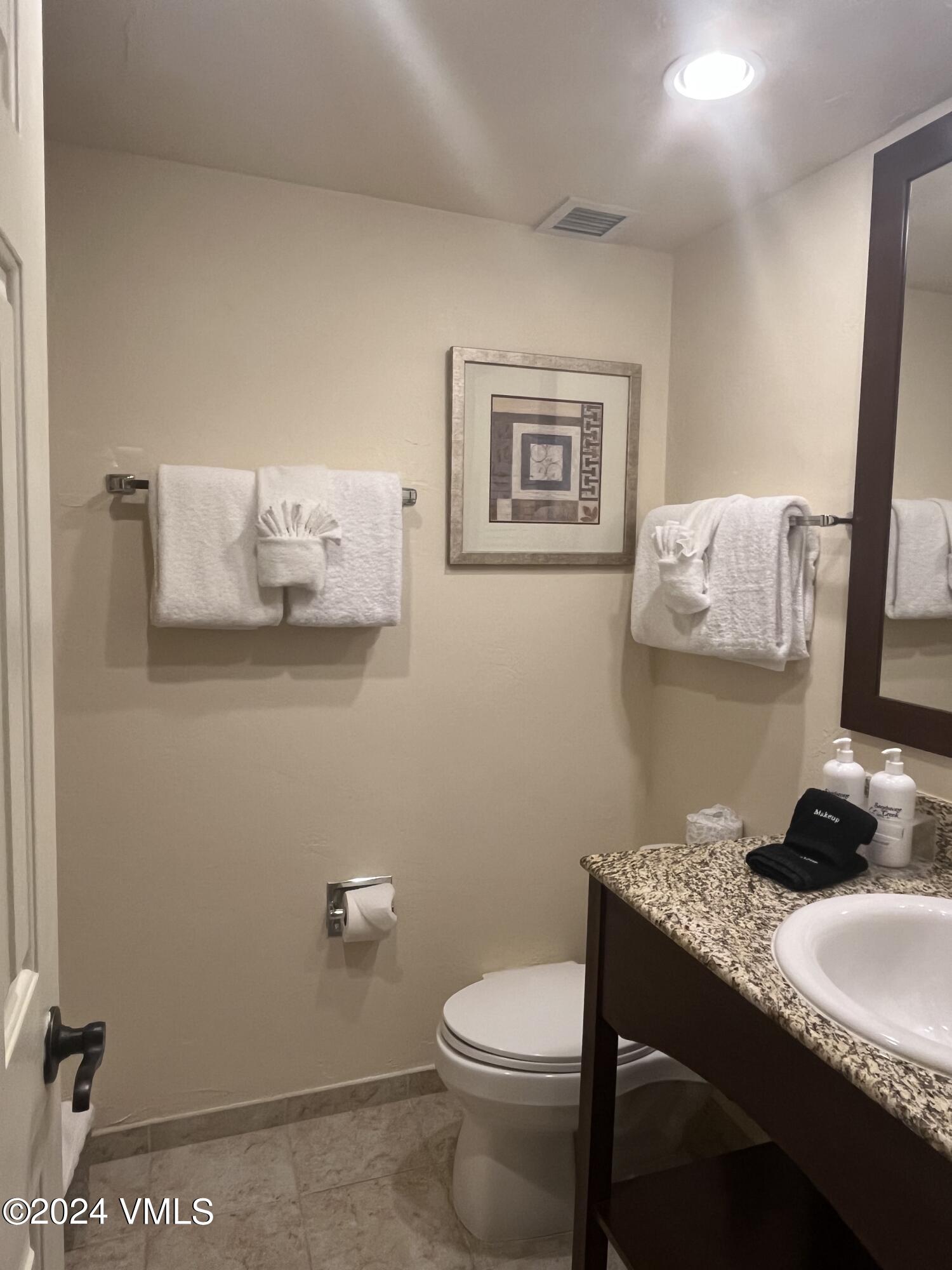 1020 Vail View Drive, Unit 340846 Vail, CO 81657 - Photo 10 of 25 a bathroom with a granite countertop toilet and a sink