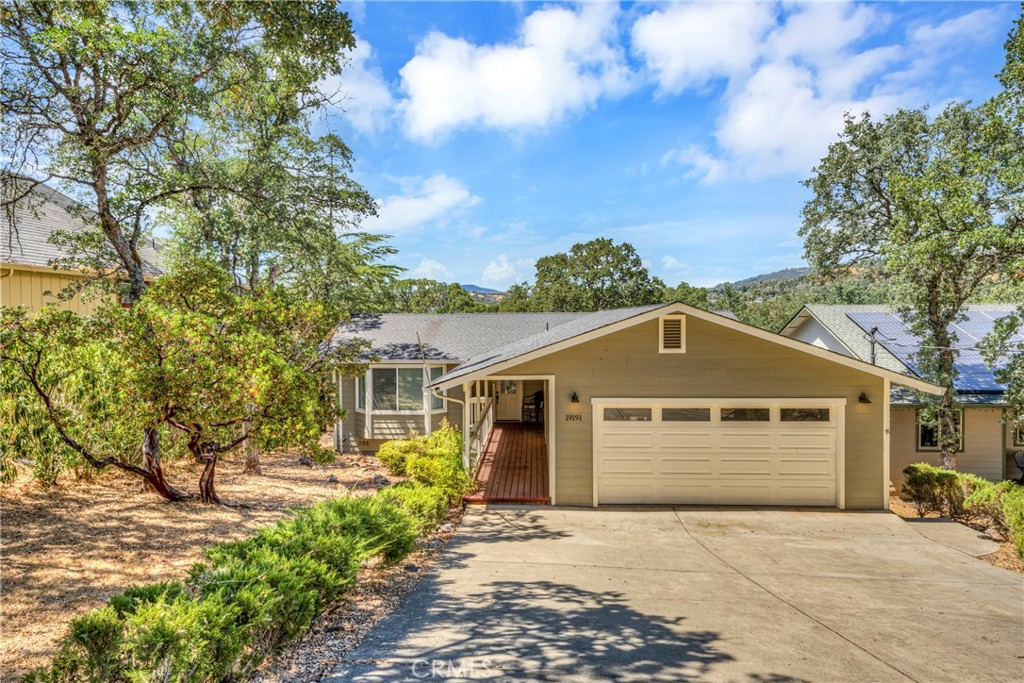 19191 Deer Hill Road Hidden Valley Lake, CA 95467 - Photo 1 of 32 a front view of a house with a yard and garage