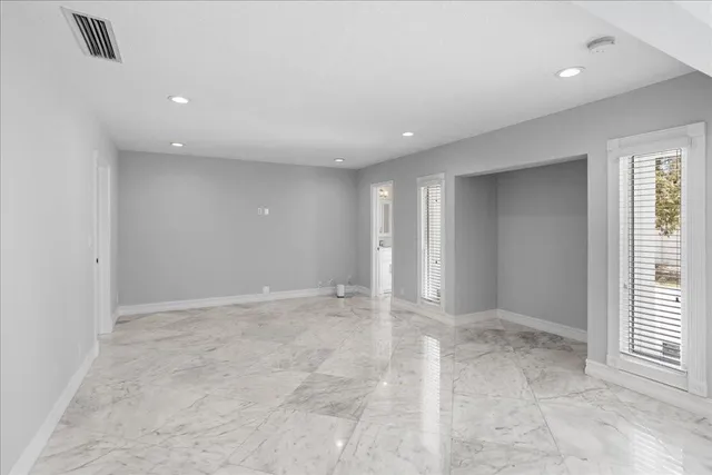 an empty room with windows and closet