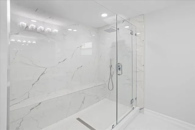 a bathroom with a shower and a glass door