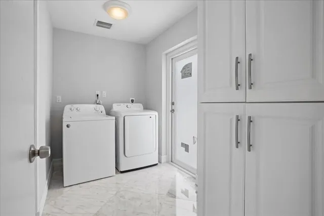 a view of utility room with dryer and washer