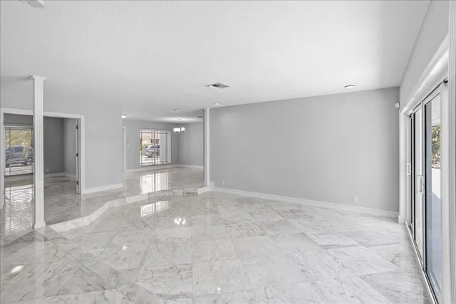 en empty room with windows and entrance