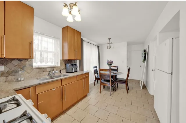 a dining room with a chandelier furniture and a window