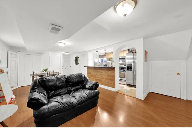 a living room with furniture and kitchen view