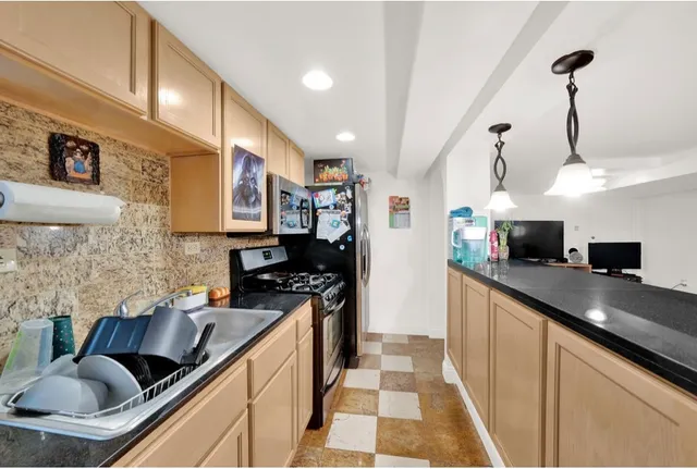 a kitchen with stainless steel appliances granite countertop a sink and cabinets