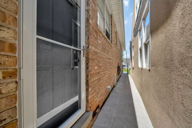 a bathroom with a granite countertop sink mirror vanity and toilet