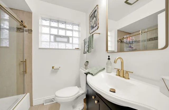 a bathroom with a sink a toilet and shower curtain