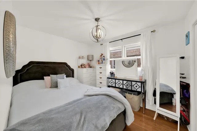 a bedroom with bed and a window