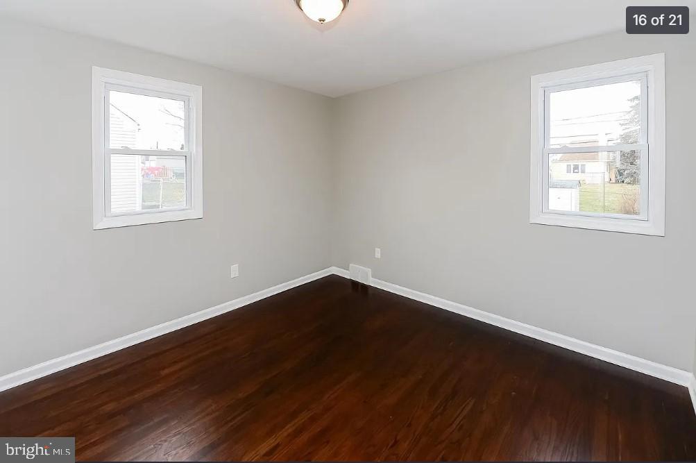 112 Upland Road Brookhaven, PA 19015 - Photo 16 of 21 an empty room with wooden floor and windows