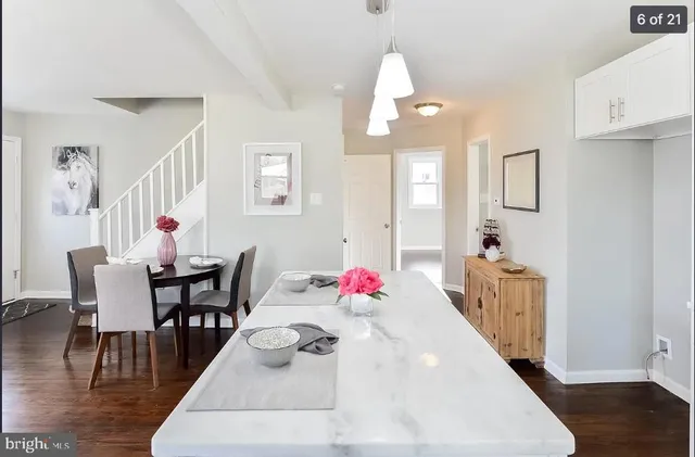 a living room with furniture dining table and wooden floor