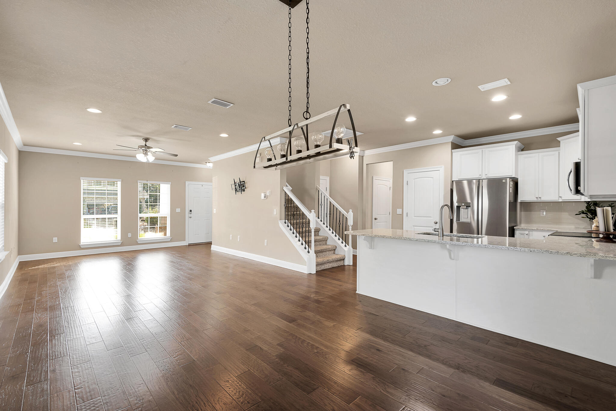 40 Constance Court Santa Rosa Beach, FL 32459 - Photo 11 of 44 a view of empty room with wooden floor and kitchen view