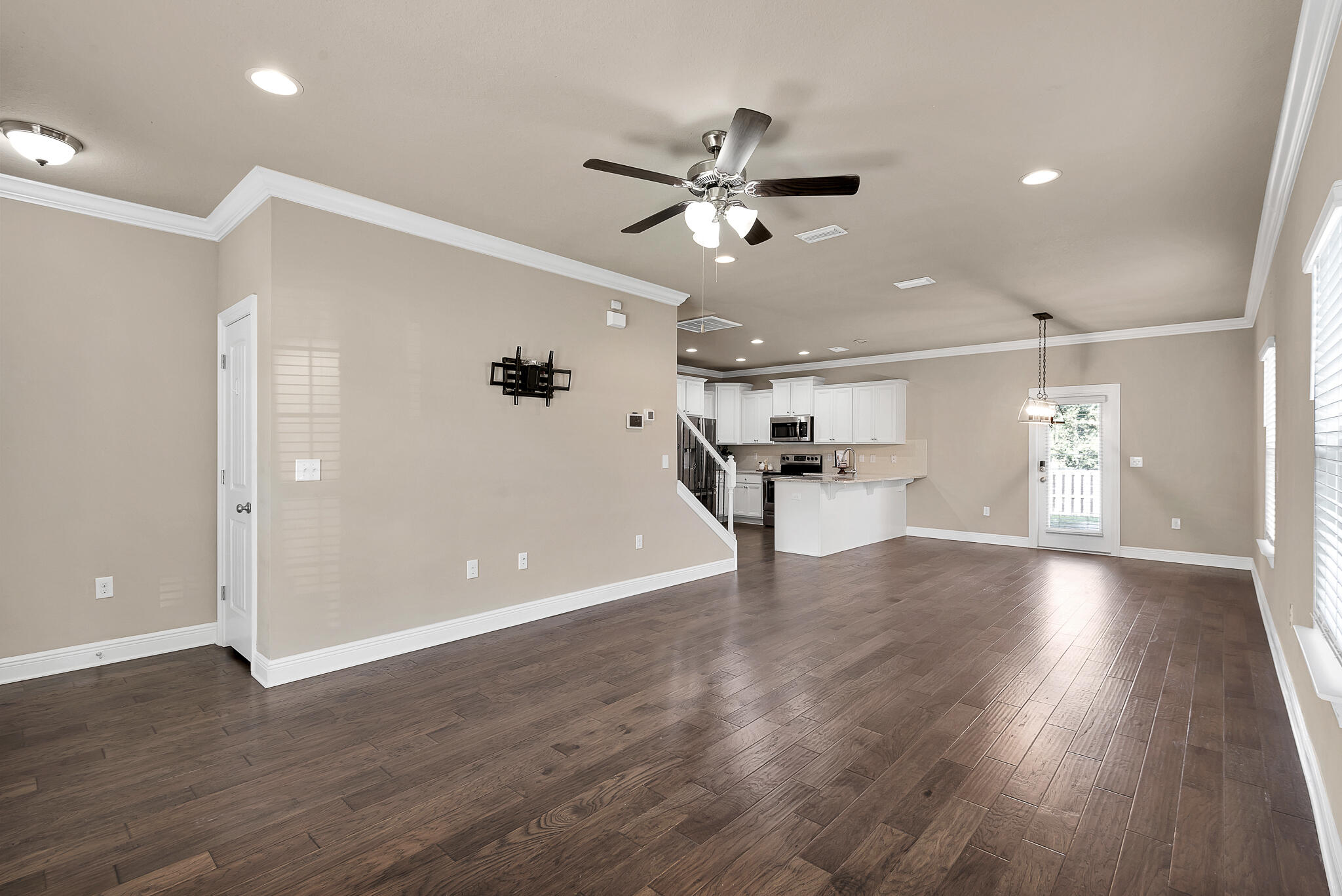 40 Constance Court Santa Rosa Beach, FL 32459 - Photo 17 of 44 a view of an empty room with wooden floor and a ceiling fan