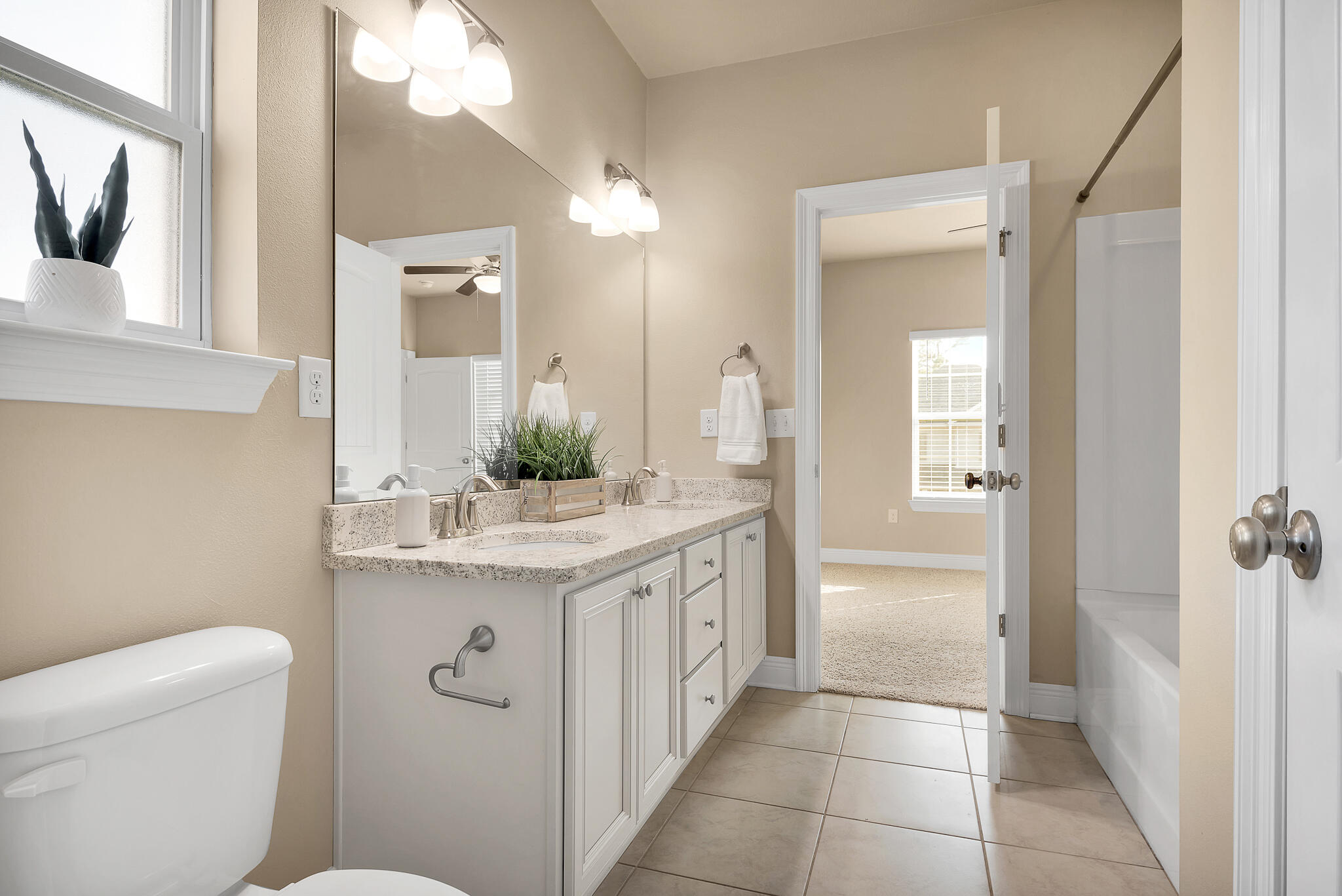 40 Constance Court Santa Rosa Beach, FL 32459 - Photo 27 of 44 a bathroom with a granite countertop sink a toilet and a mirror