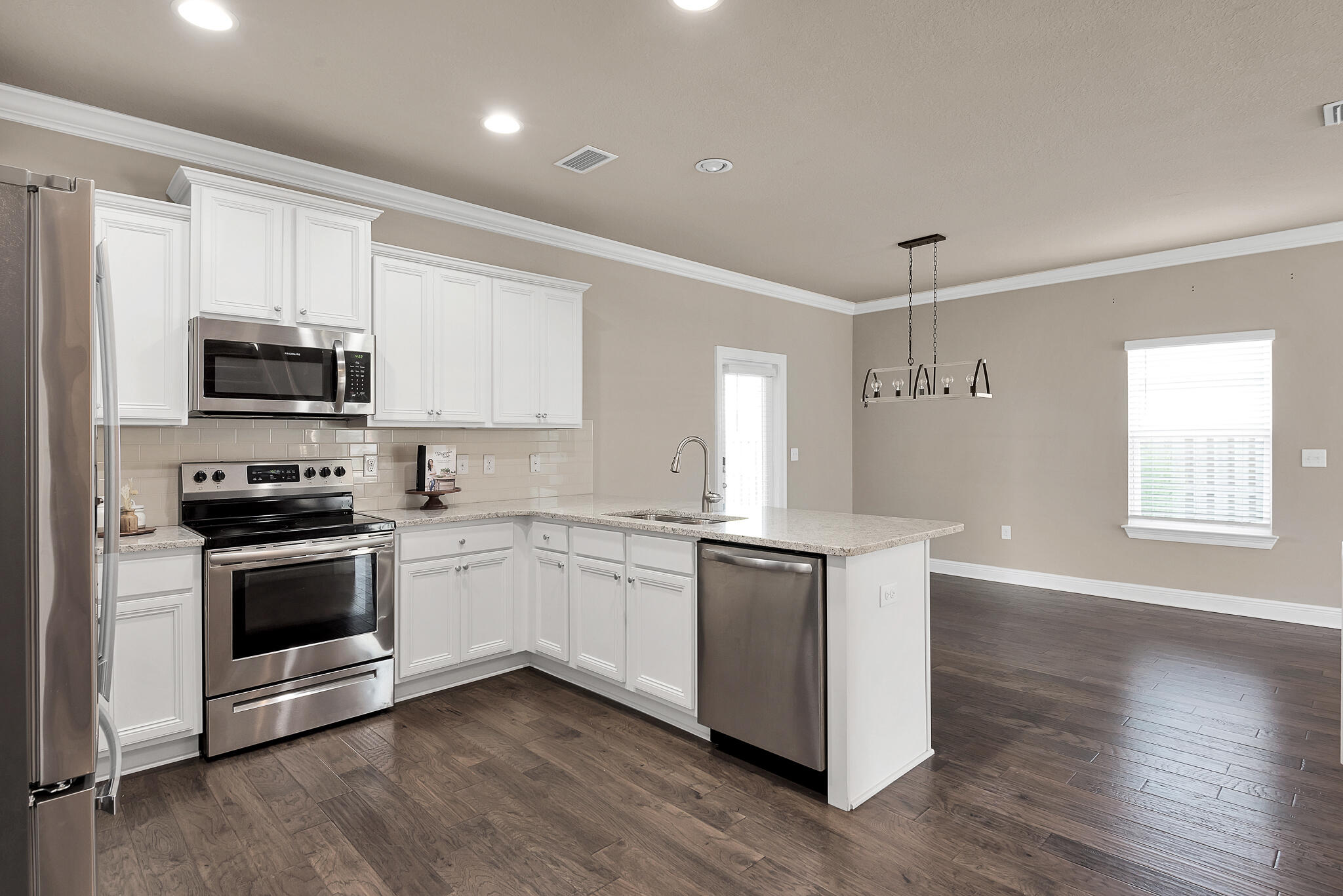 40 Constance Court Santa Rosa Beach, FL 32459 - Photo 8 of 44 a kitchen with stainless steel appliances granite countertop a stove a sink and a microwave
