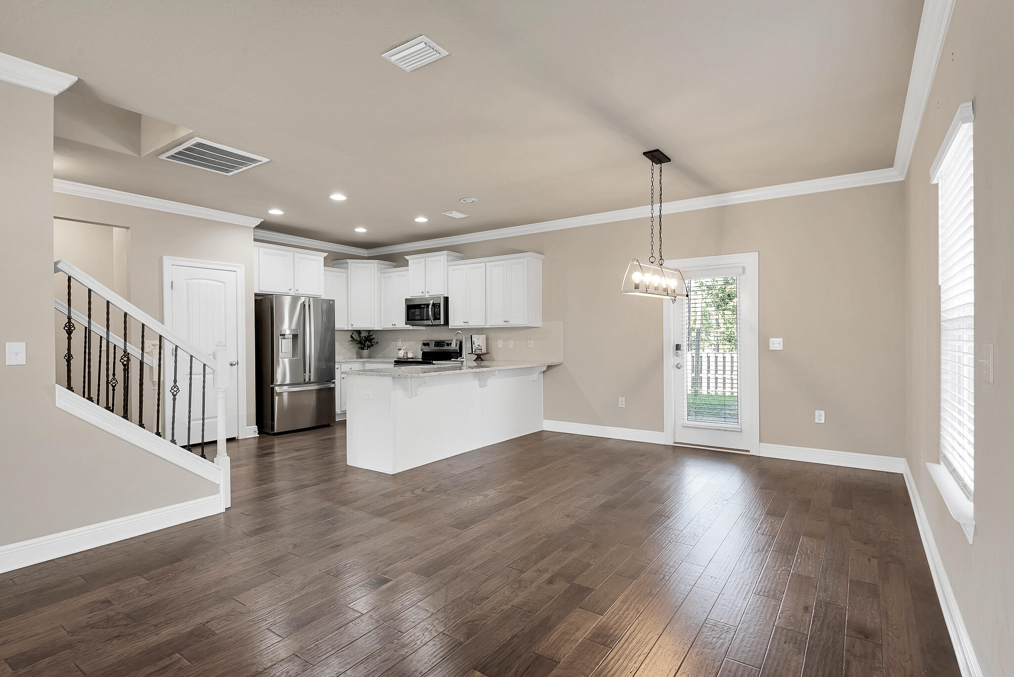 40 Constance Court Santa Rosa Beach, FL 32459 - Photo 10 of 44 a view of an empty room with wooden floor and kitchen view