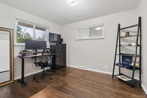 a view of a workspace with furniture and a window