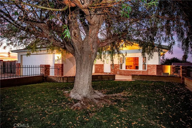 a blue house with trees in front of it