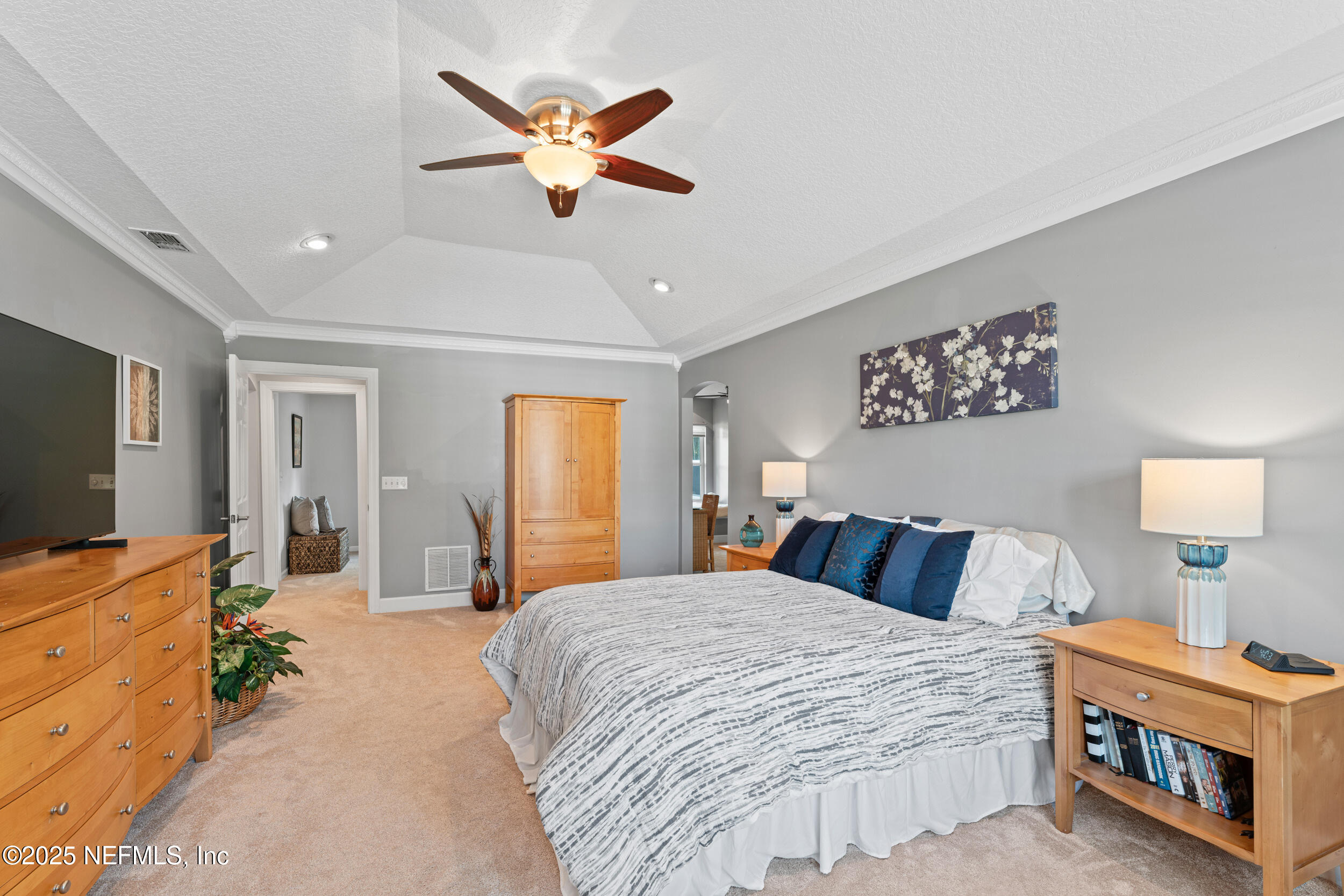 1475 Course View Drive Fleming Island, FL 32003 - Photo 20 of 70 a bedroom with a bed and a flat screen tv