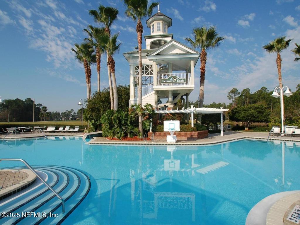 1475 Course View Drive Fleming Island, FL 32003 - Photo 54 of 70 a view of a swimming pool with a table and chairs potted plants