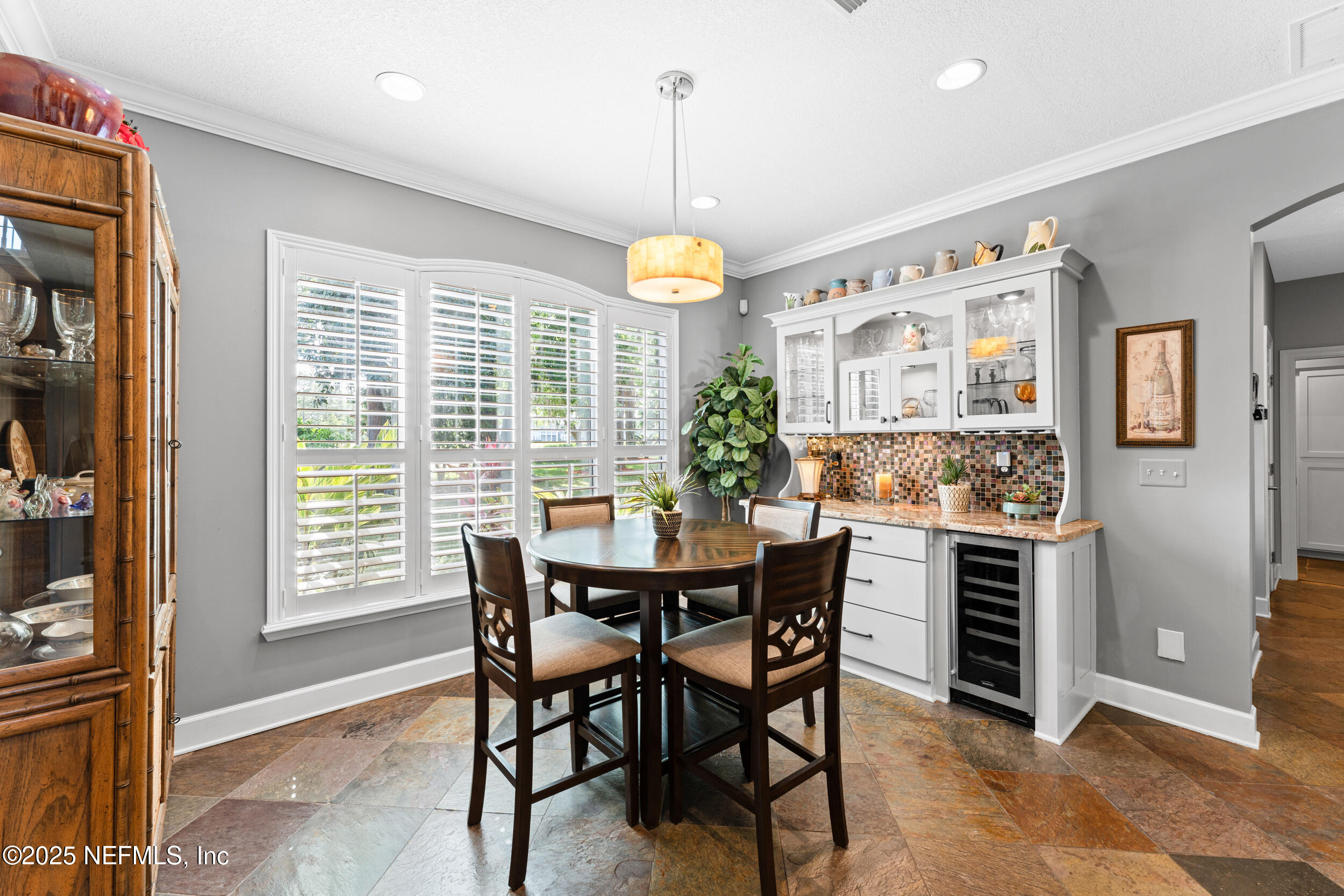 1475 Course View Drive Fleming Island, FL 32003 - Photo 8 of 70 a dining room with furniture a chandelier and window