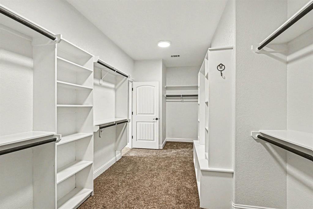 104 Stanford Lane Springtown, TX 76082 - Photo 18 of 28 a view of walk in closet with empty racks