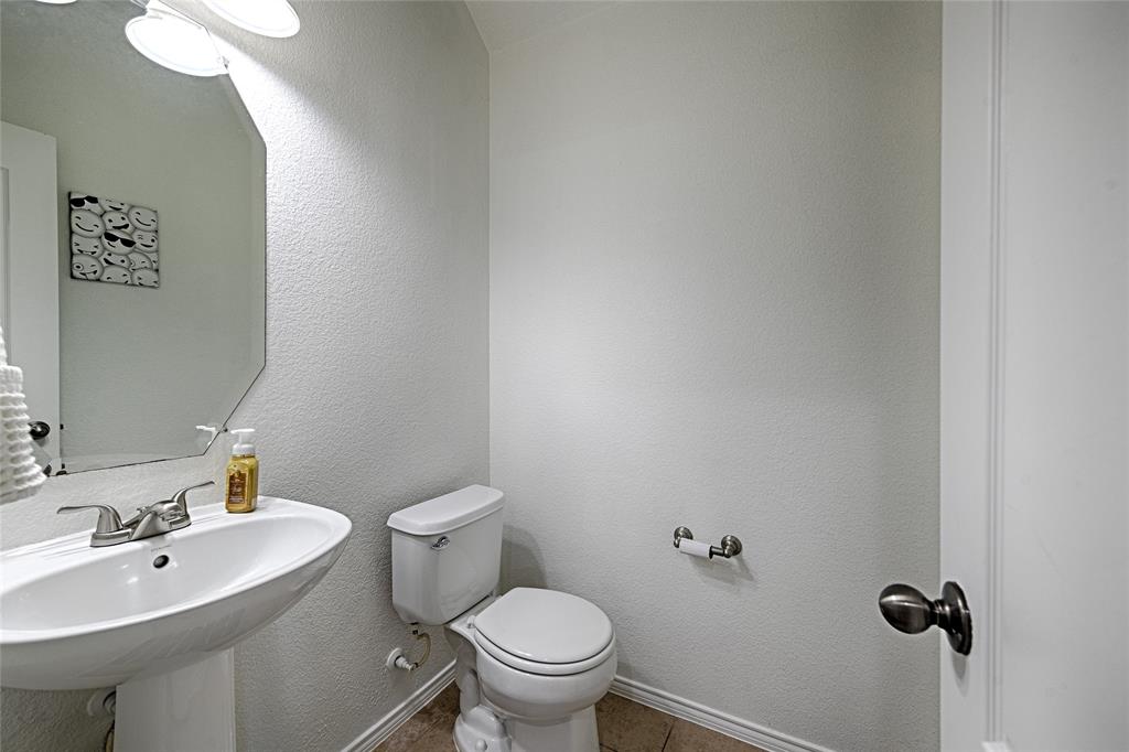 5984 Stone Mountain Road The Colony, TX 75056 - Photo 12 of 25 a bathroom with a sink mirror and toilet