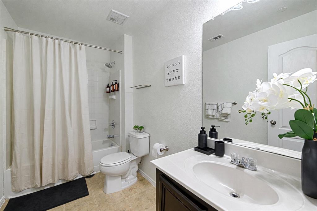 5984 Stone Mountain Road The Colony, TX 75056 - Photo 13 of 25 a bathroom with a sink toilet and shower
