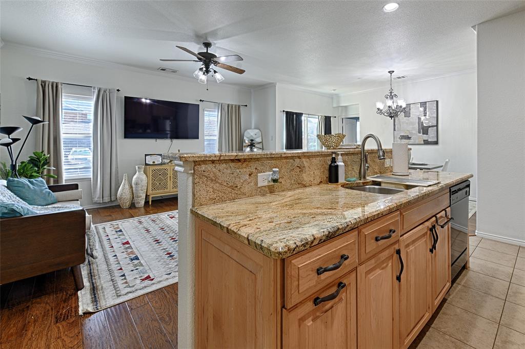 5984 Stone Mountain Road The Colony, TX 75056 - Photo 14 of 25 a living room with granite countertop furniture and a flat screen tv