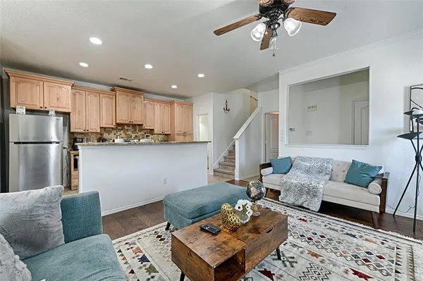 a living room with furniture and kitchen view