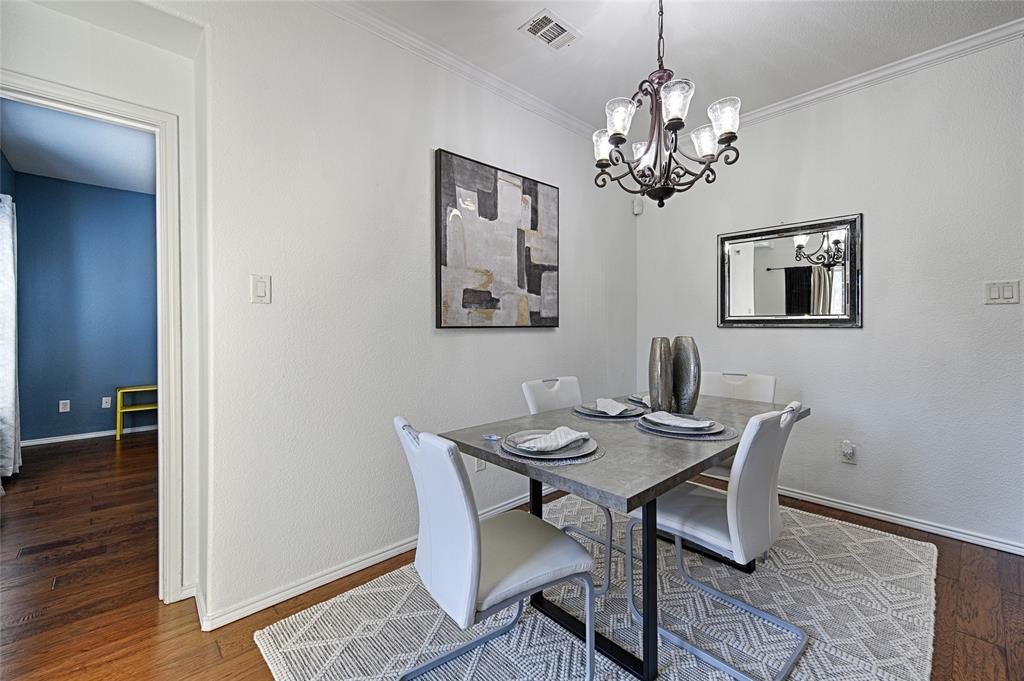 5984 Stone Mountain Road The Colony, TX 75056 - Photo 17 of 25 a view of a dining room with furniture and chandelier