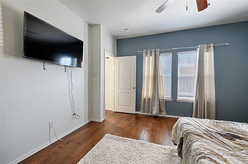 5984 Stone Mountain Road The Colony, TX 75056 - Photo 20 of 25 a view of bedroom with wooden floor and window