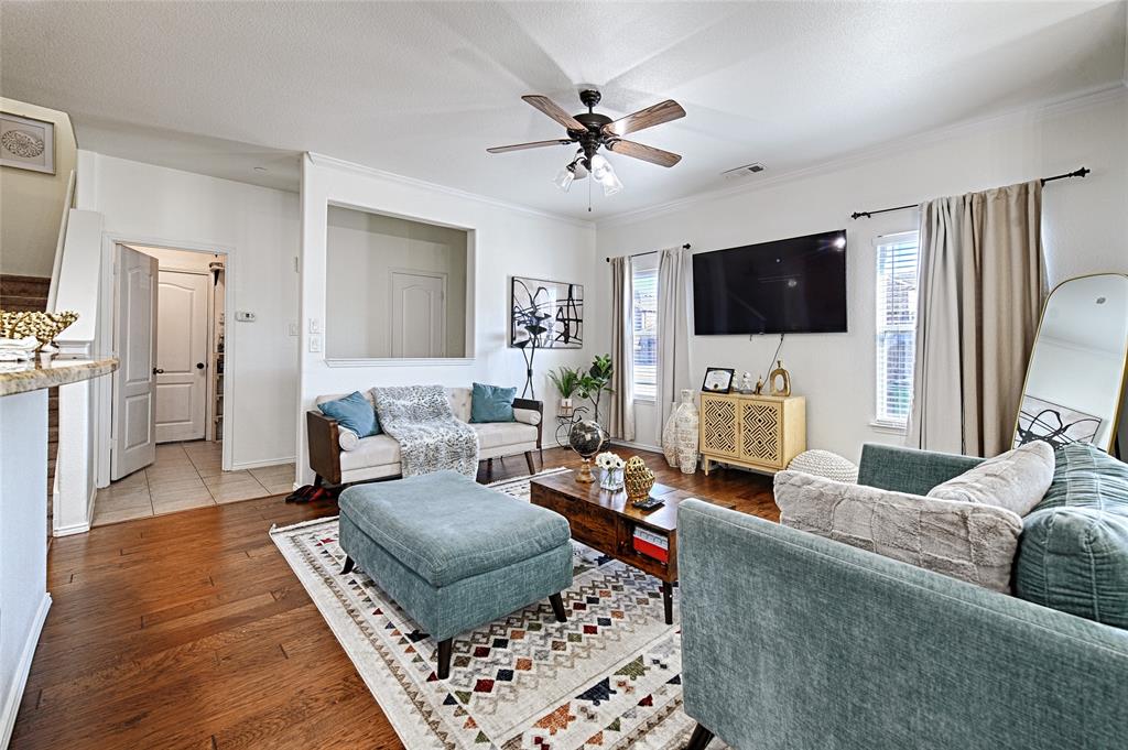 5984 Stone Mountain Road The Colony, TX 75056 - Photo 2 of 25 a living room with furniture and a flat screen tv