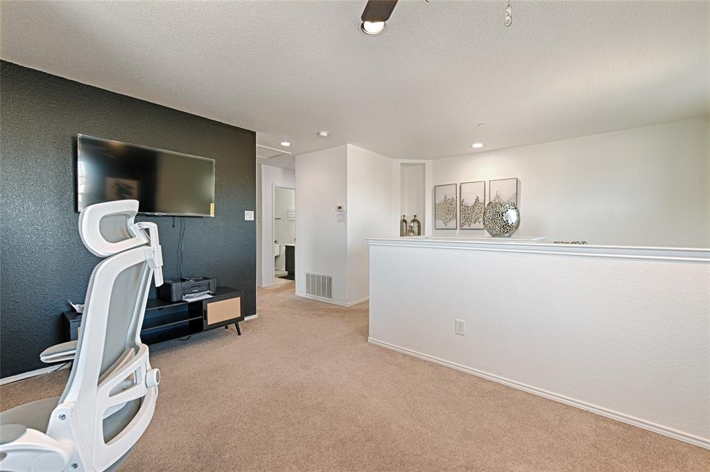5984 Stone Mountain Road The Colony, TX 75056 - Photo 22 of 25 a living room with furniture and a flat screen tv
