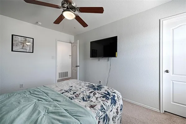 a bedroom with a bed and a flat screen tv
