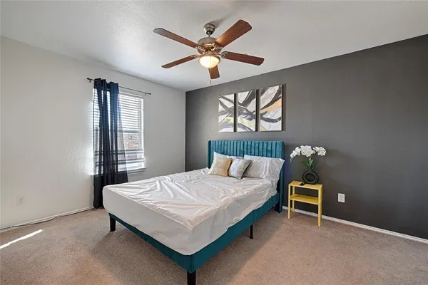 a bedroom with a bed and a window