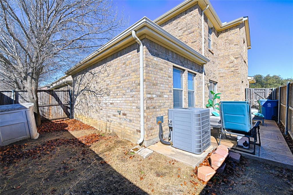 5984 Stone Mountain Road The Colony, TX 75056 - Photo 10 of 25 a view of a chairs and table in the backyard
