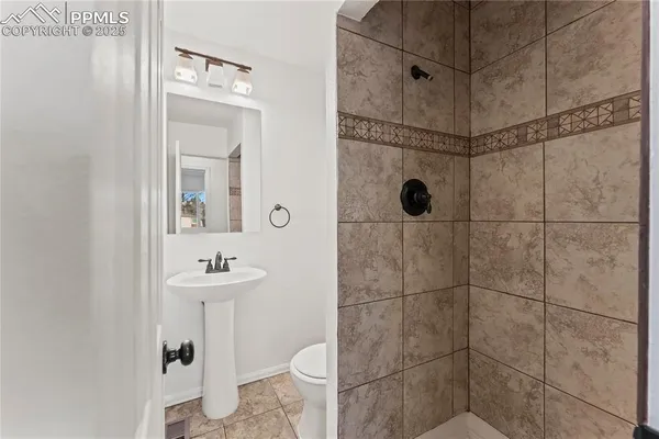 a bathroom with a sink toilet and shower
