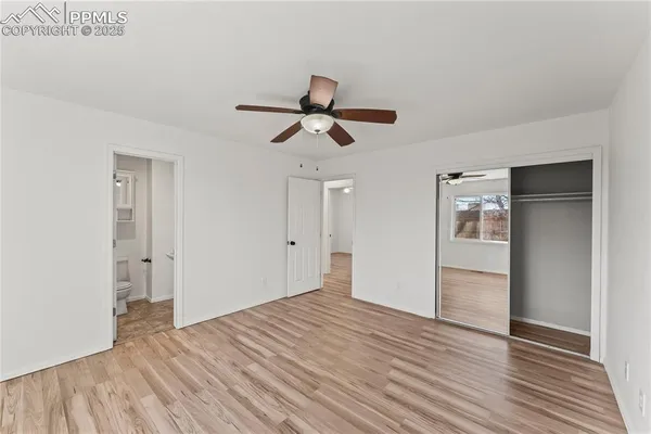 a view of empty room with wooden floor