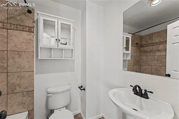 a bathroom with a sink toilet and shower