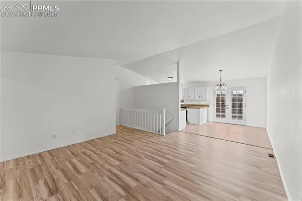 a view of empty room with wooden floor and fireplace