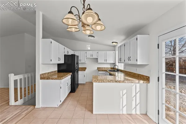 a very nice looking kitchen with a large window
