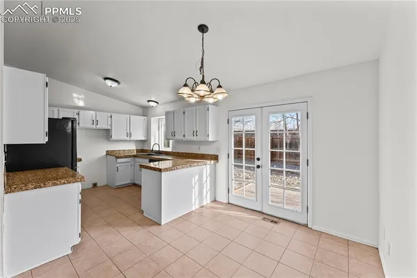 a kitchen with kitchen island granite countertop a stove a sink dishwasher and a refrigerator